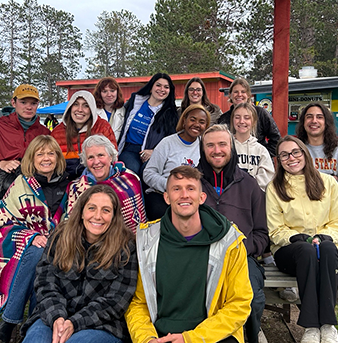group photo of individuals seated outdoors